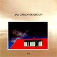 Jan GARBAREK GROUP photo with blue, white cloud, wires, Windows and a Red Roof 